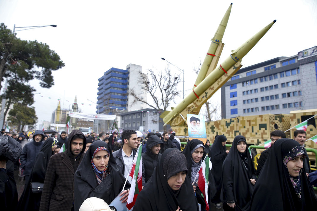 Iranians walk past a missile during a rally marking the 40th anniversary of the 1979 Islamic Revolution, in Tehran, Iran,