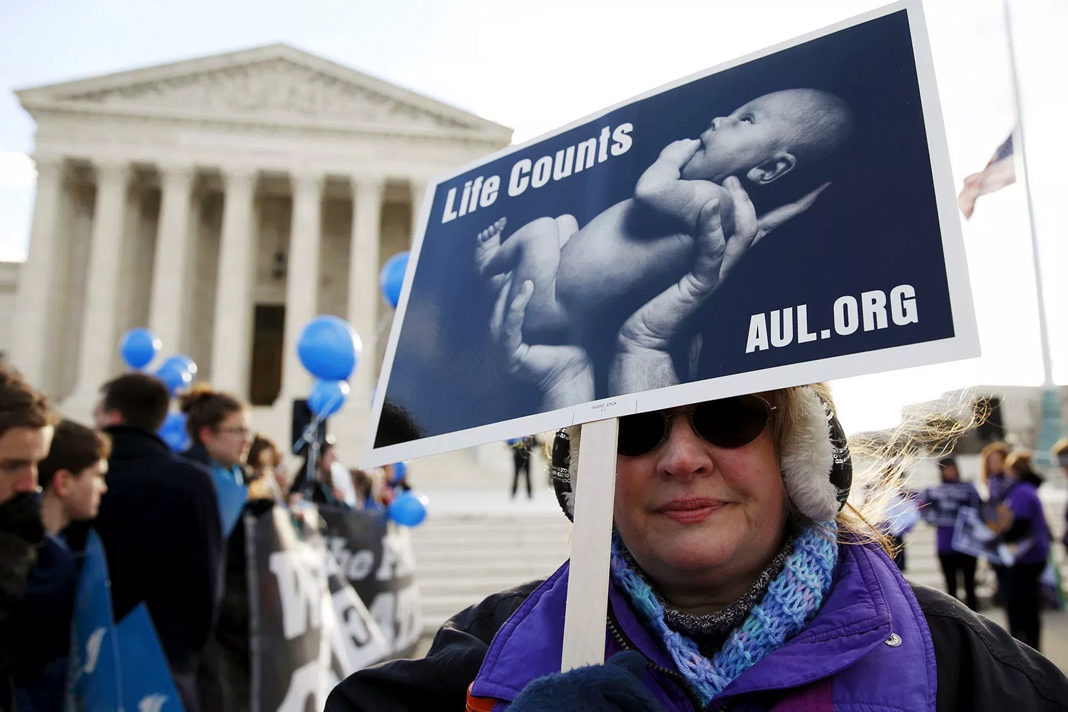 A pro-life marcher holds a sign outside the Supreme Court in Washington, D.C., March 2, 2016. (Kevin Lamarque/Reuters)