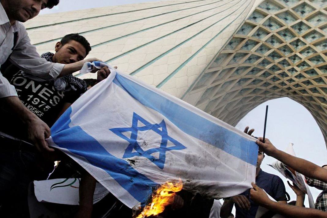 iran-inches-closer-toward-its-goal-of-wiping-israel-off-the-map Iranians burn an Israeli flag. (AP/Vahid Salemi)