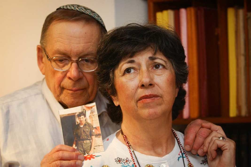 Miriam and Yoni Baumel hold a picture of their son Zachary Baumel, who went missing in 1982. (Flash90)