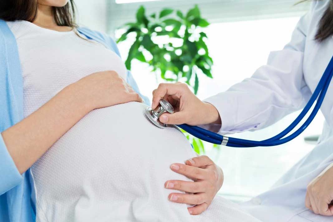 Doctor listening to baby heart beat