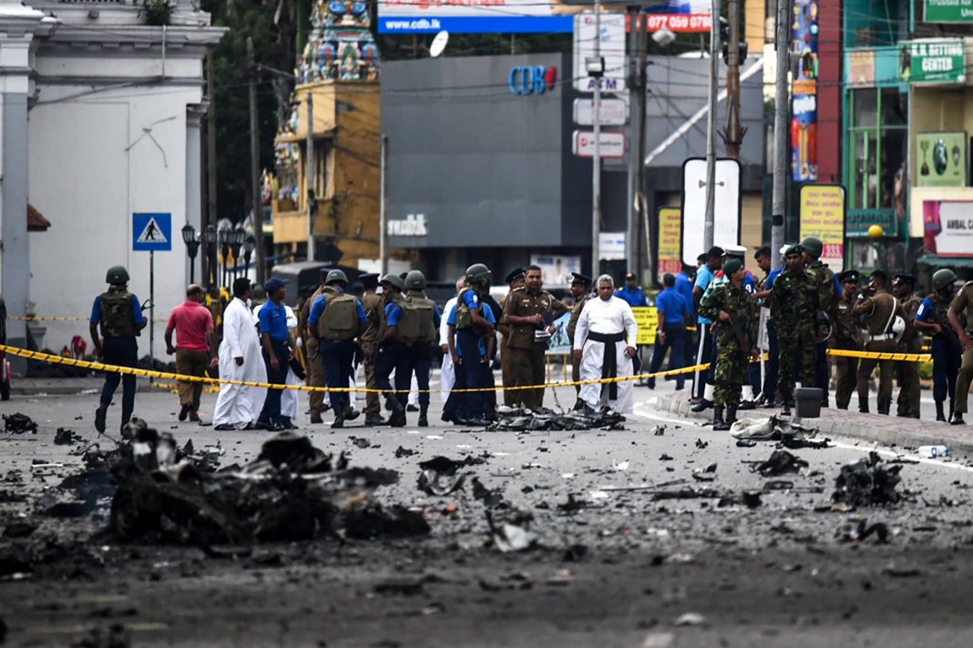video-emerges-of-bomber-entering-sri-lanka-church-as-death-toll-tops-310 Sri Lankan security personnel inspect the debris of a car after it explodes when police tried to defuse a bomb near St. Anthony’s Shrine as priests look on in Colombo on April 22, 2019, a day after the series of bomb blasts targeting churches and luxury hotels in Sri Lanka. (Jewel SAMAD / AFP)