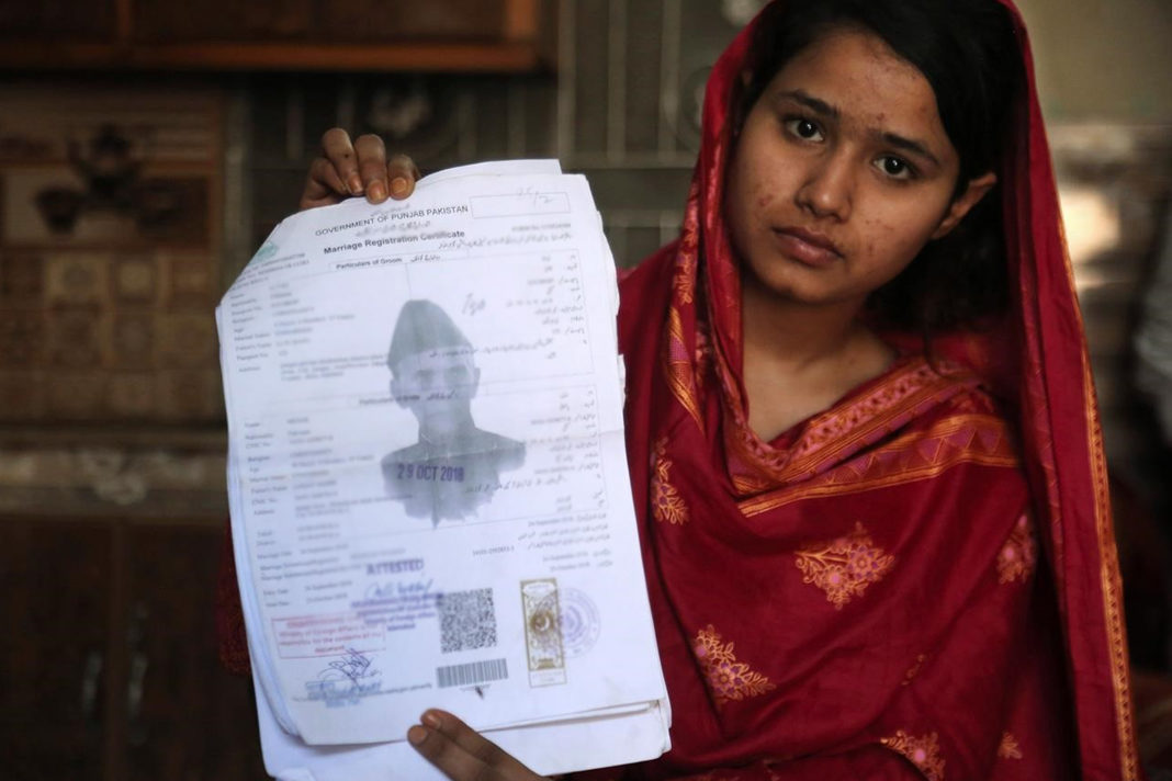 Mahek Liaqat, who married a Chinese national, shows her marriage certificate in Gujranwala, Pakistan.