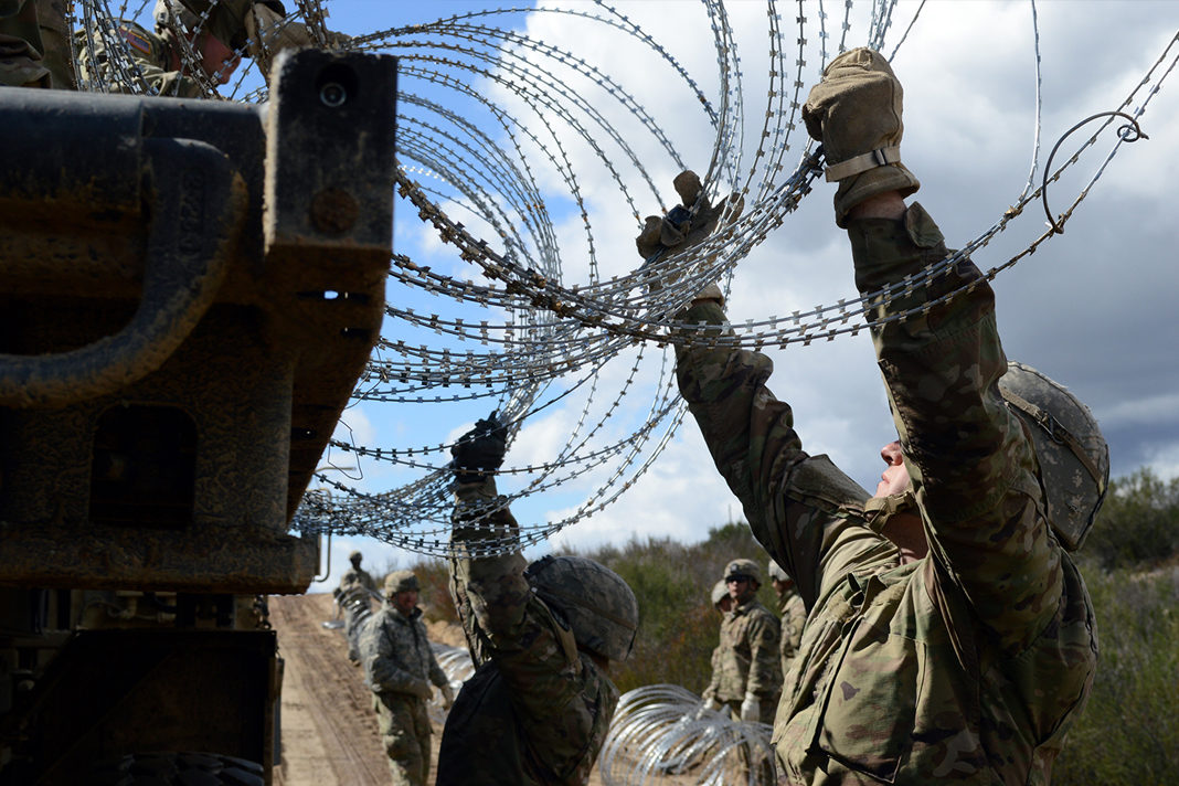 Soldiers emplace strands of concertina wire along the border fence on March 8, 2019, near Campo, Calif. (Sgt. 1st Class Ben K. Navratil/U.S. Army)