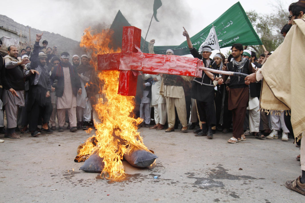 People burning Cross