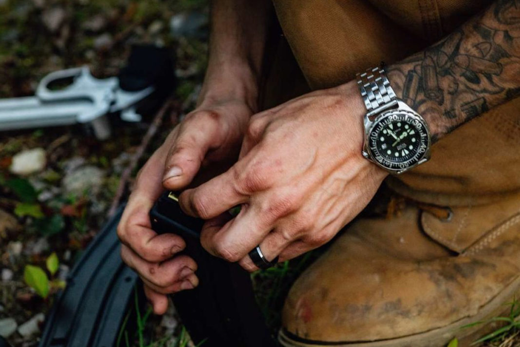 person holding loading gun