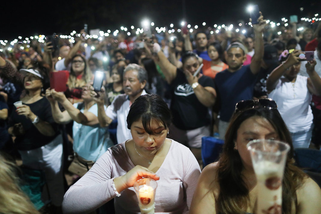 5-responses-to-the-el-paso-dayton-shootings-that-left-29-dead People hold up their phones in lieu of candles at an interfaith vigil for victims of a mass shooting, which left at least 20 people dead, on August 4, 2019 in El Paso, Texas. A 21-year-old male suspect was taken into custody in the city which sits along the U.S.-Mexico border. At least 26 people were wounded. | Getty Images/Mario Tama