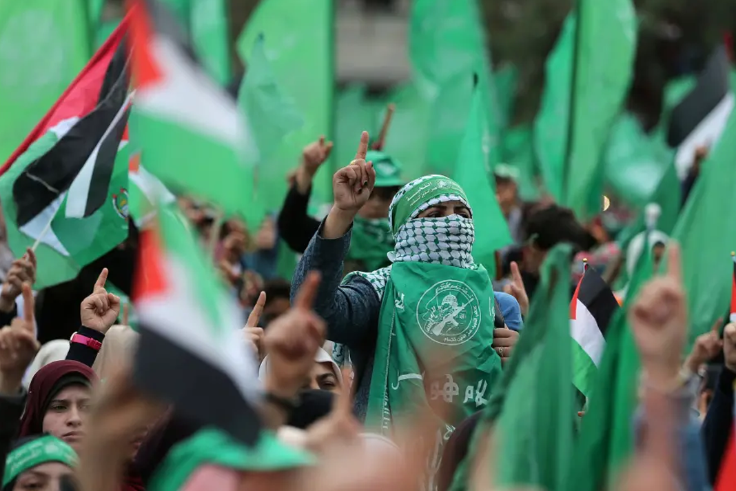 gaza-terror-groups-will-join-hezbollah-israel-war Palestinians take part in a rally marking the 31st anniversary of Hamas' founding, in Gaza City. (photo credit: IBRAHEEM ABU MUSTAFA / REUTERS)