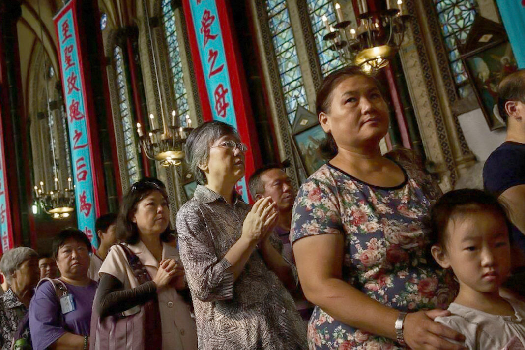 chinese-house-churches-directed-to-worship-the-communist-party Chinese Catholics worship at a church in Beijing (Kevin Frayer / Getty Images)