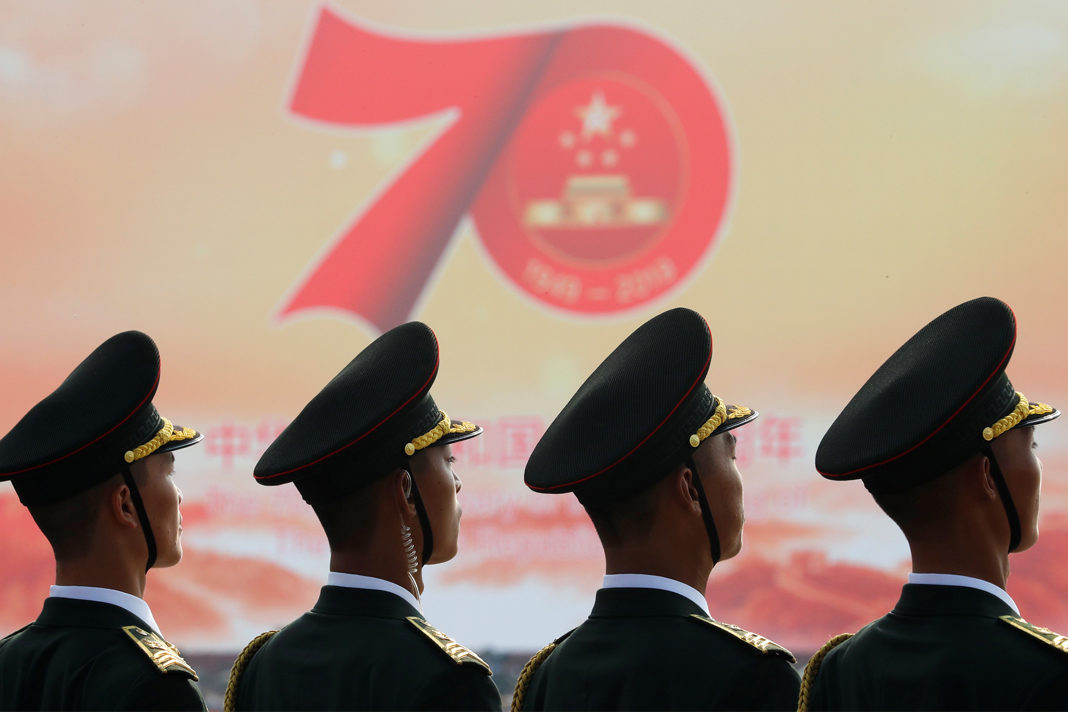 human-rights-worst-ever-as-communist-china-celebrates-70th-anniversary Soldiers of People's Liberation Army (PLA) are seen in front of a sign marking the 70th founding anniversary of People's Republic of China before a military parade on its National Day in Beijing, China October 1, 2019. (Photo: Thomas Peter/Reuters)