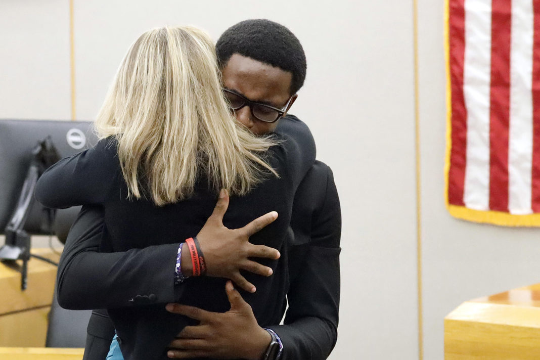 young-christian-publicly-forgives-his-brothers-murderer Botham Jean's younger brother, Brandt Jean, hugs former Dallas police officer Amber Guyger after delivering his victim-impact statement.