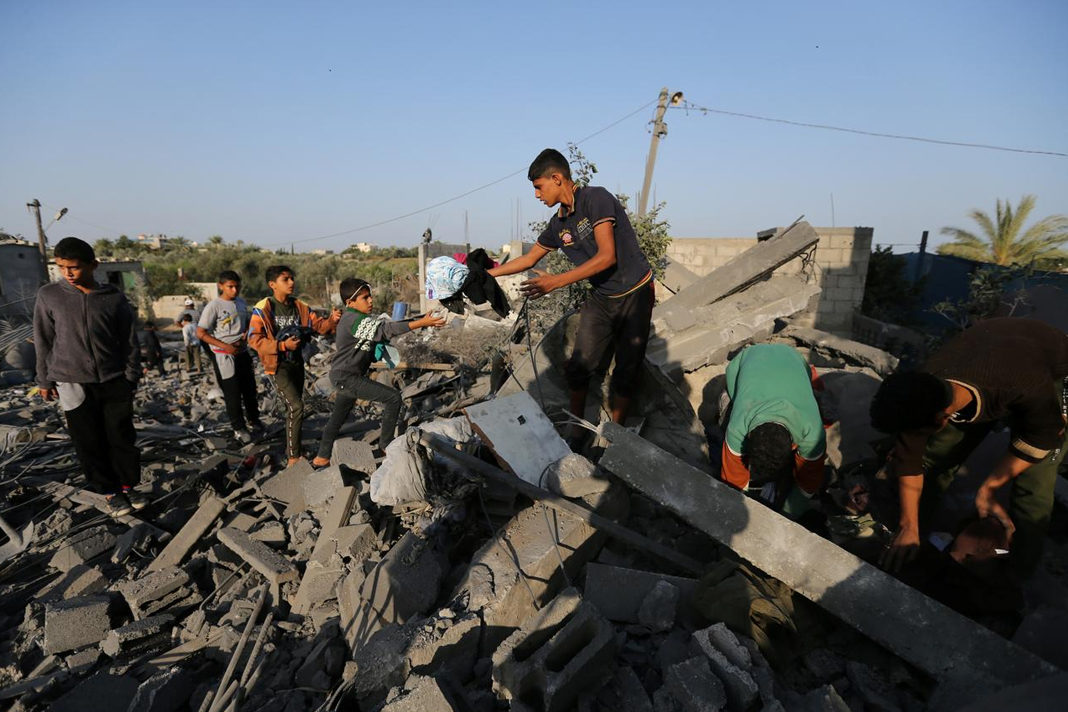 calm-in-gaza-as-israel-reach-truce-with-islamic-jihad-group Palestinians collect belongings from a house destroyed in an Israeli air strike in the southern Gaza Strip on Thursday. Image Credit: ANI