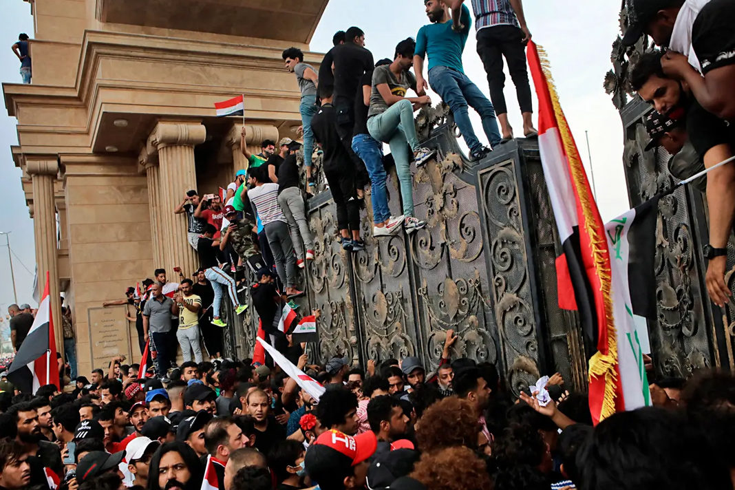 iraqi-church-faces-pressure-over-protests Anti-government protesters try to break into the provincial council building during a demonstration in Basra. AP