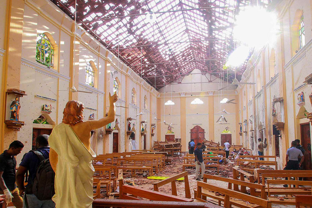 A blood-stained statue of Jesus Christ is pictured while officials inspect the site of a bomb blast, as the sun shines through the blown-out roof, inside St Sebastian's Church in Negombo, Sri Lanka, April 21, 2019. / Reuters Photo