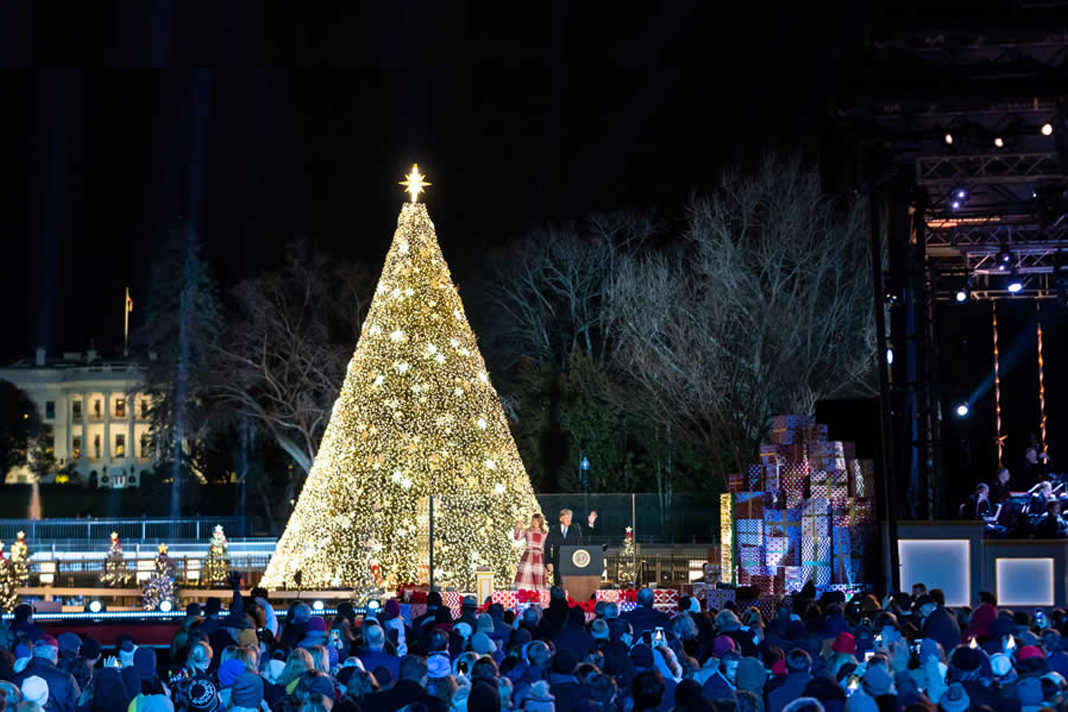 trump-tells-the-christmas-story-praises-salvation-army-at-national-christmas-tree-lighting-ceremony President Donald Trump and First Lady Melania Trump wave to guests attending the 97th annual National Christmas Tree Lighting Ceremony on Thursday, Dec. 5, 2019, in Washington, D.C. Official White House Photo by Andrea Hanks