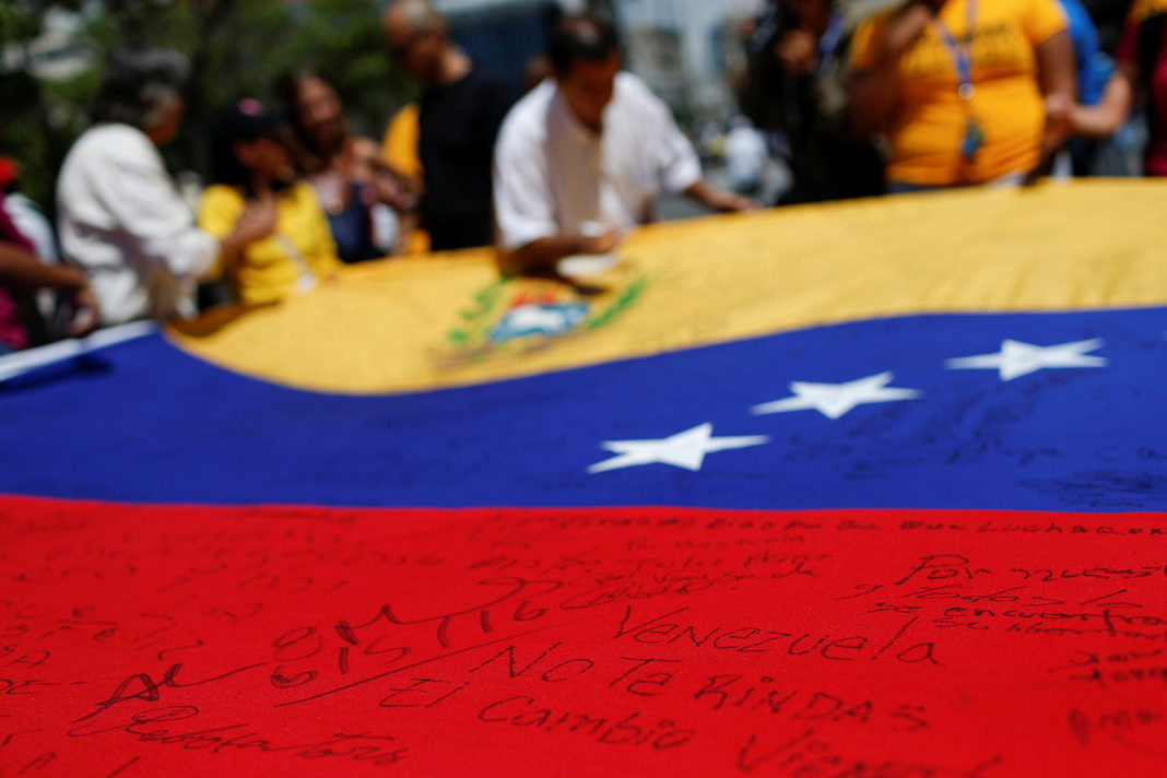 venezuelans-turning-to-prayer,-not-politics A message written on a Venezuelan national flag that reads,