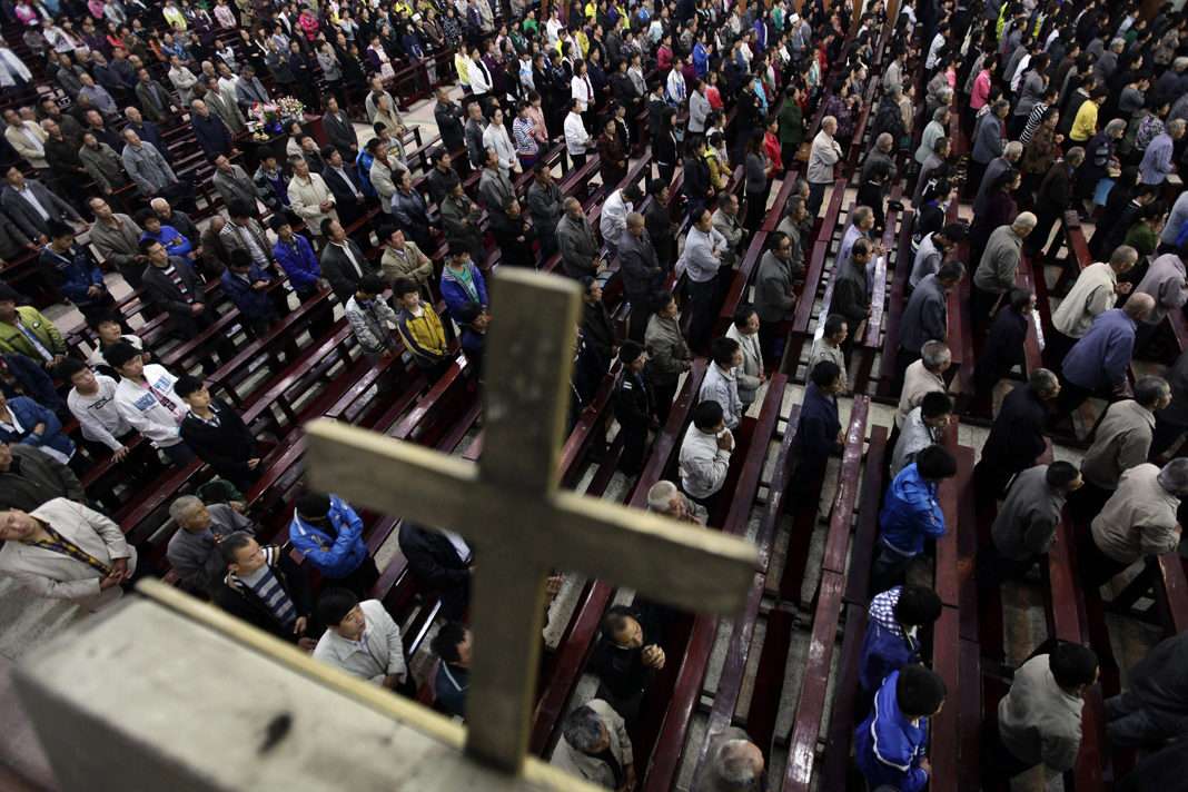 Worshippers pray during a mass in the morning at the Liuhe Catholic Church in Liuhe village on the outskirts of Qingxu county, northern China's Shanxi province, Sept. 11, 2011.