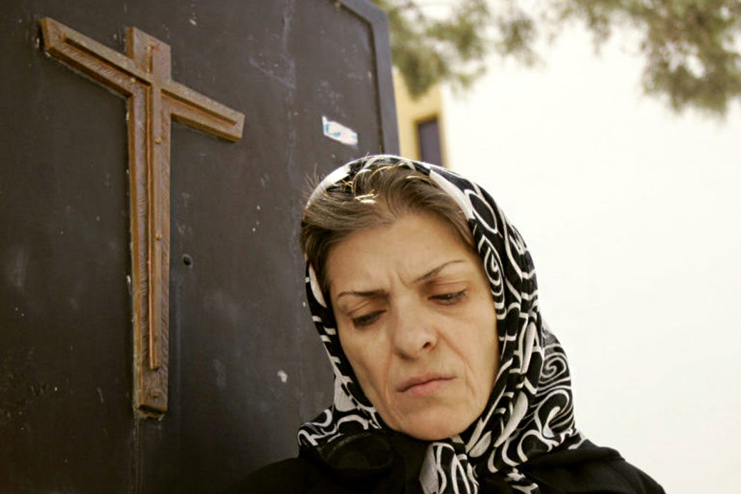 iran-collaborative-report-details-ongoing-violations-of-freedom-of-religion-or-belief-against-christians An Iranian Christian woman leaves a church after a prayer ceremony in Tehran September 17, 2006. REUTERS/Morteza Nikoubazl(IRAN)