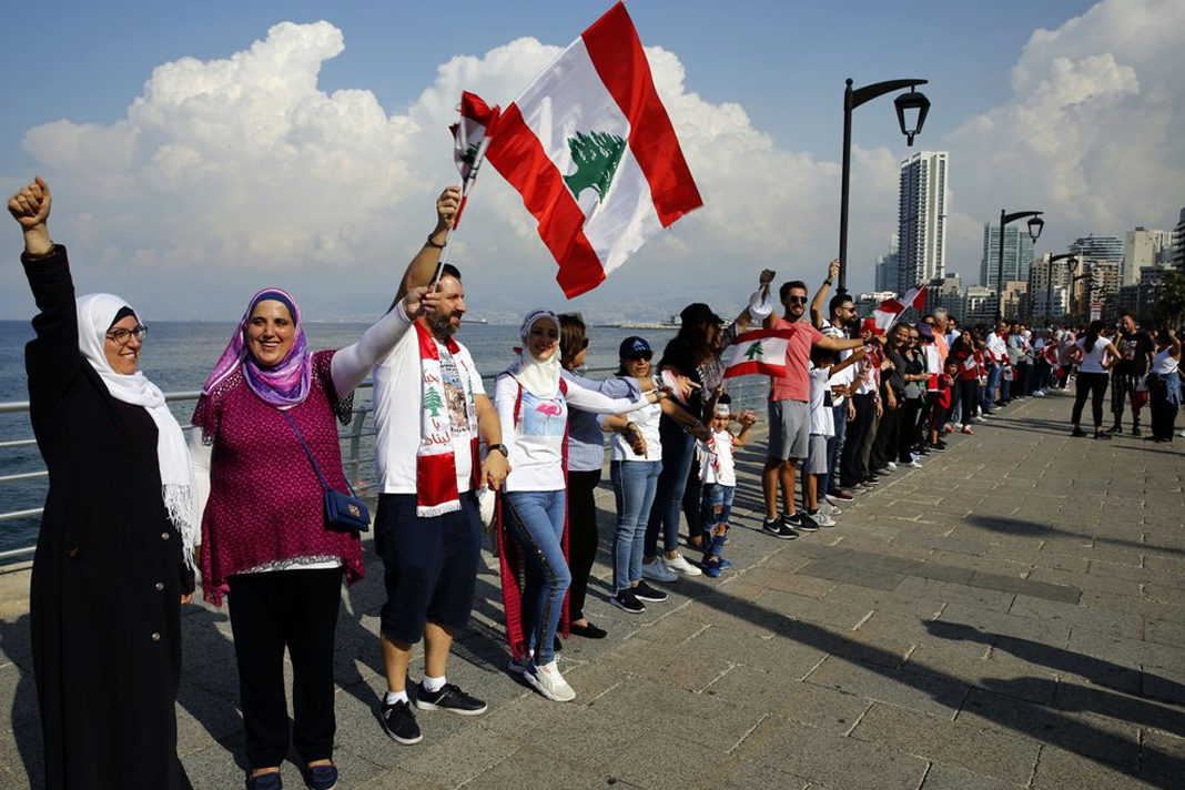 in-lebanon-christians-and-muslims-are-united-in-ongoing-demonstrations Anti-government protesters form a human chain as a symbol of unity, during ongoing protests against the Lebanese government, on the Mediterranean waterfront promenade, in Beirut, Lebanon. (AP Photo/Bilal Hussein)