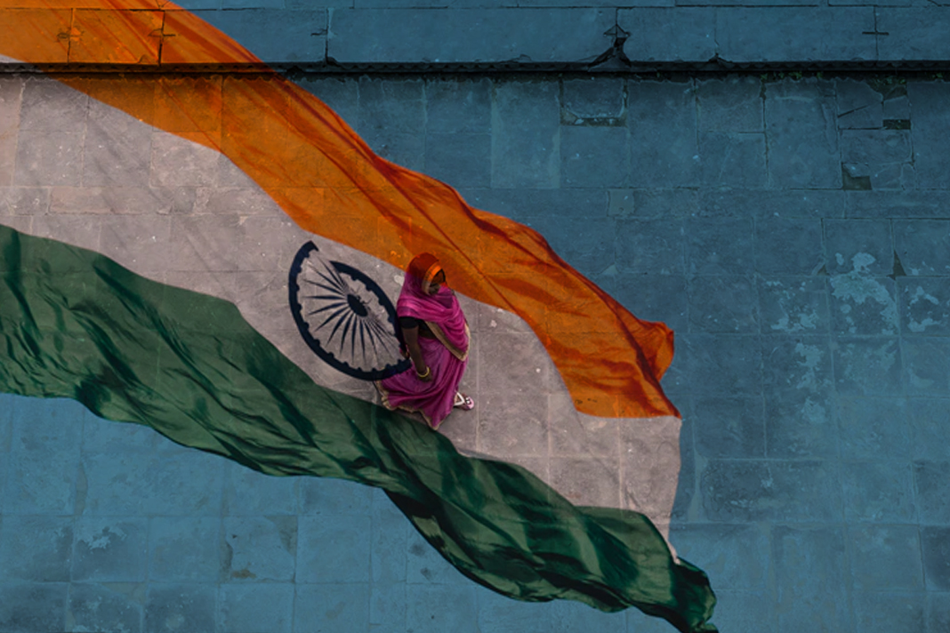 how-one-mother-trapped-in-sexual-slavery-refuses-to-let-her-daughter-suffer-this-pain Indian woman in a pink dress with Indian flag