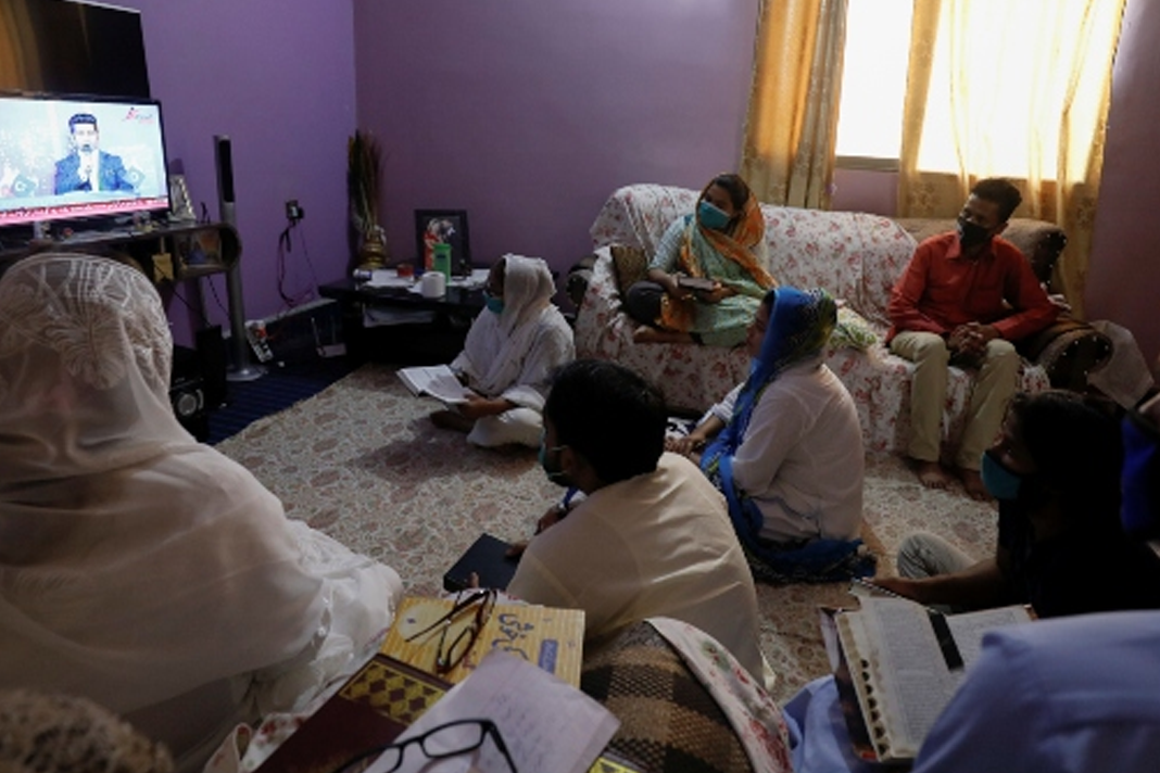 pakistani-christians-facing-extra-difficulties-during-covid-19-because-of-their-faith Christian family members hold holy books as they attend Good Friday prayer session via streaming on television in Karachi, Pakistan, April 10, 2020. (Reuters/Akhtar Soomro)
