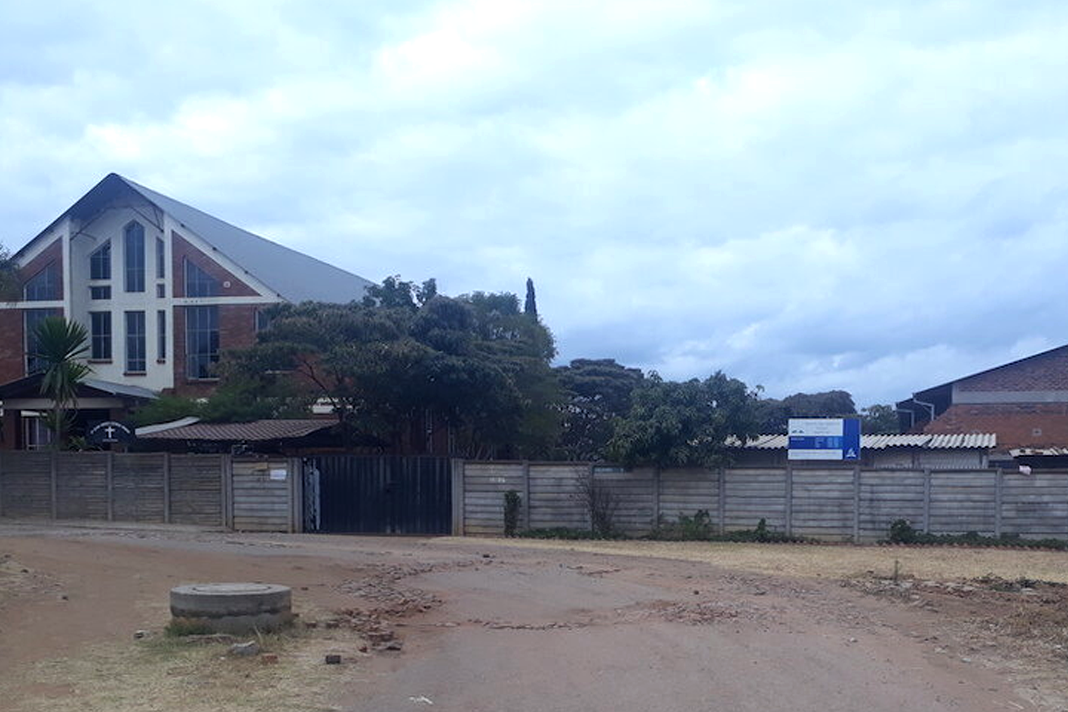 zimbabwean-houses-of-worship-remain-quiet-amid-changing-covid-19-rules Churches with closed gates on July 26 on Gelfand Street in Harare, Zimbabwe. Photo by Tawanda Karombo.