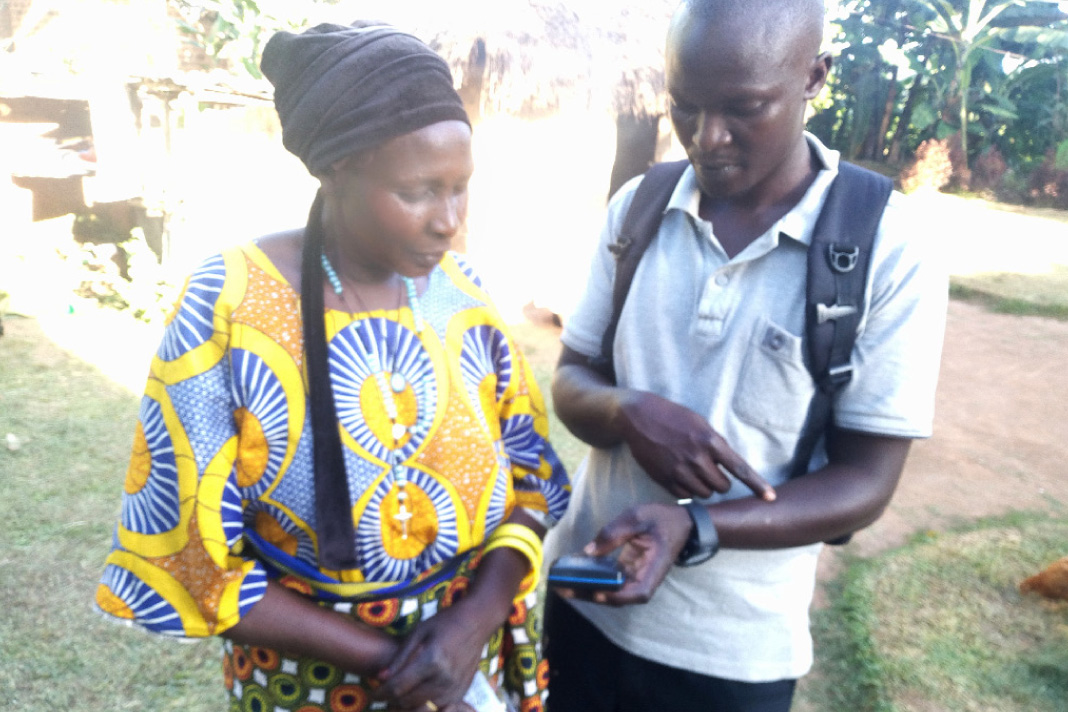 Pastor teaches lady B how to operate an Mp3 player