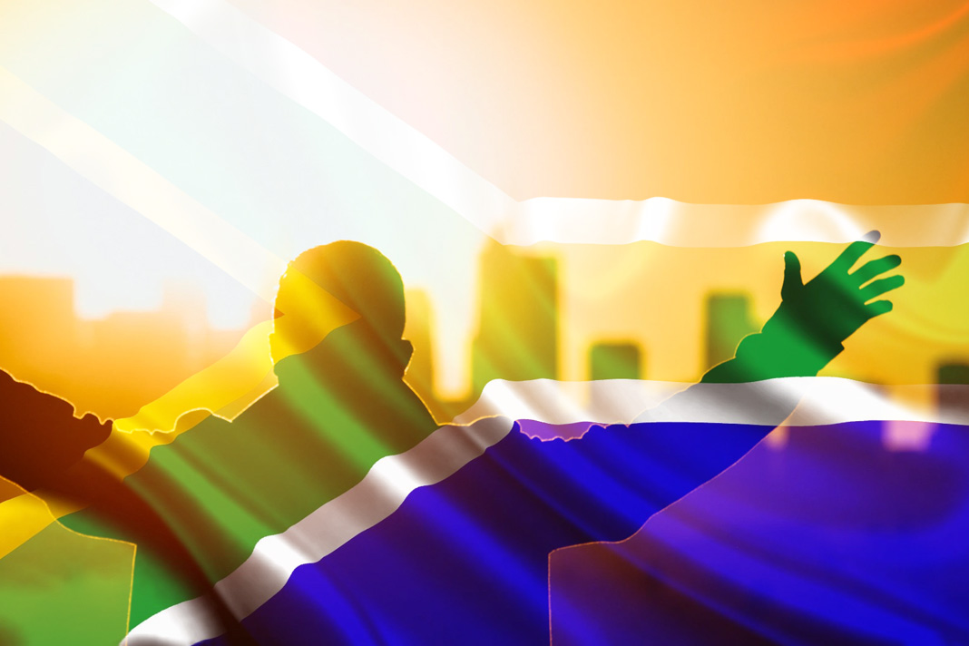 government-avoids-court-opens-up-religious-services Man with open arms and South African flag