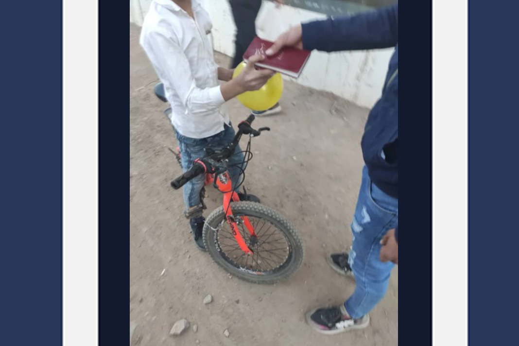 iran-sowing-gospel-seeds-through-street-ministry Person receiving a bible