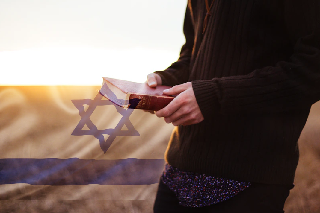 new-survey-more-young-evangelicals-turning-their-backs-on-israel Person with Bible and Israel Flag