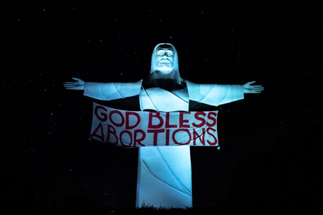 pro-abortion-group-hangs-god-bless-abortions-banner-on-statue-of-christ Banner on the Christ of the Ozarks statue in Eureka Springs, Arkansas.