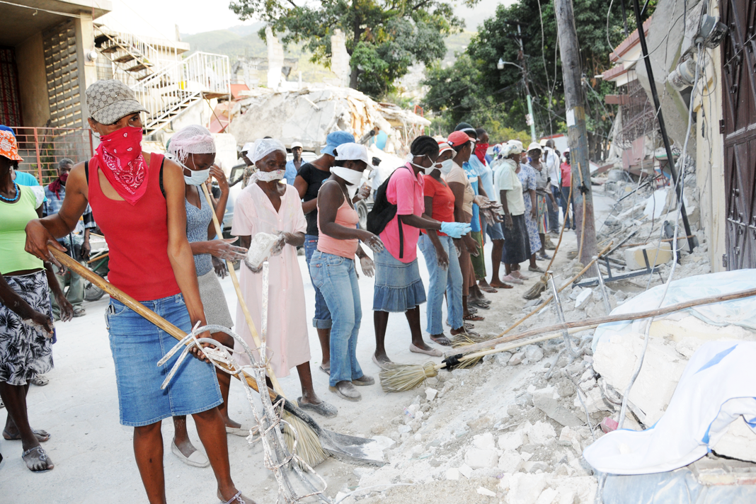 haitian-earthquake-survivor-we-only-have-jesus-now Workers in the Carrefour Feuilles neighbourhood clear rubble from the street as part of the UNDP cash for work programme. Photo by Adam Rogers / UNDP.