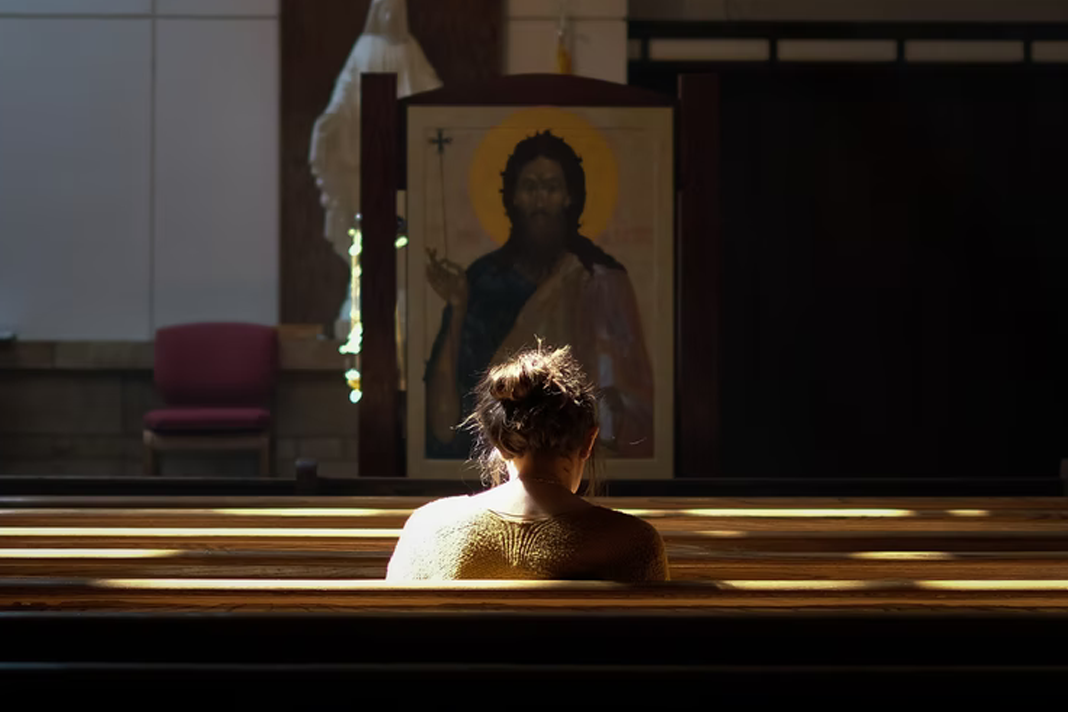 french-catholic-church-will-sell-buildings-to-help-pay-compensations-for-sexual-abuse-victims Woman sitting in cathedral